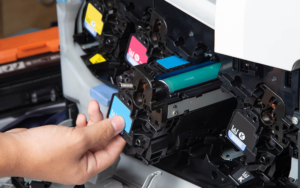 Close up of person changing laser toner