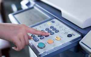 Close up view of person using buttons on printer