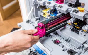 Person pulling out toner cartridges from printer