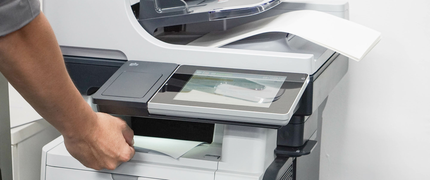 Person using copy machine in office space