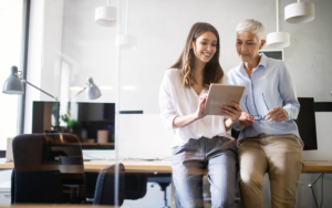 Two people looking over tablet in office