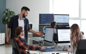 Various workers on computers inside office