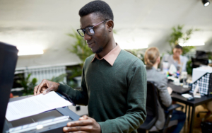 View of a person using the scanner on multi function printer