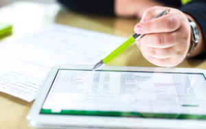 Close up view of a person looking at data on tablet