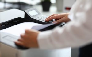 Close up view of person using desktop printer