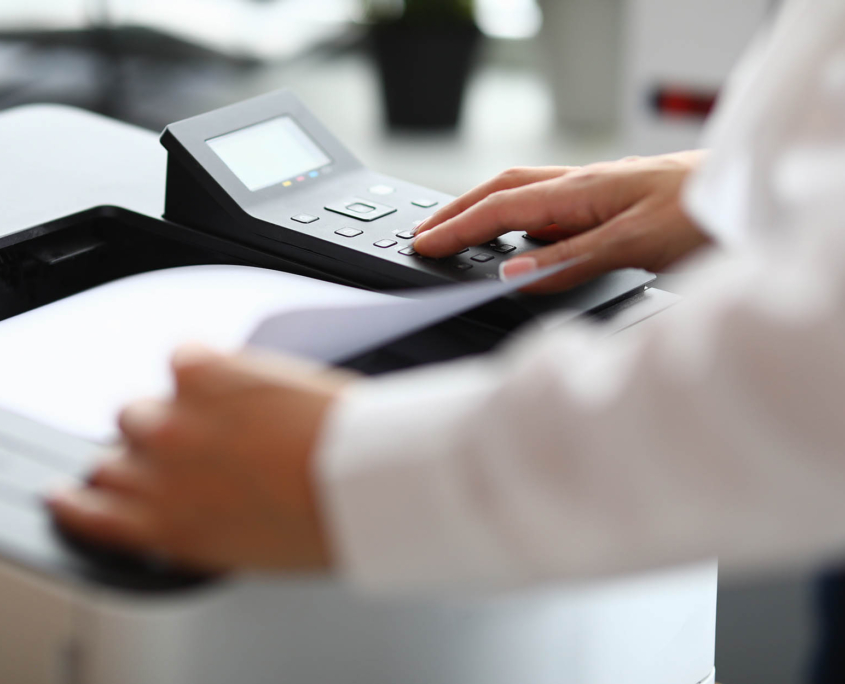 Close up view of person using desktop printer