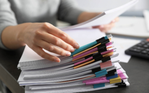 Person looking through a stack of documents