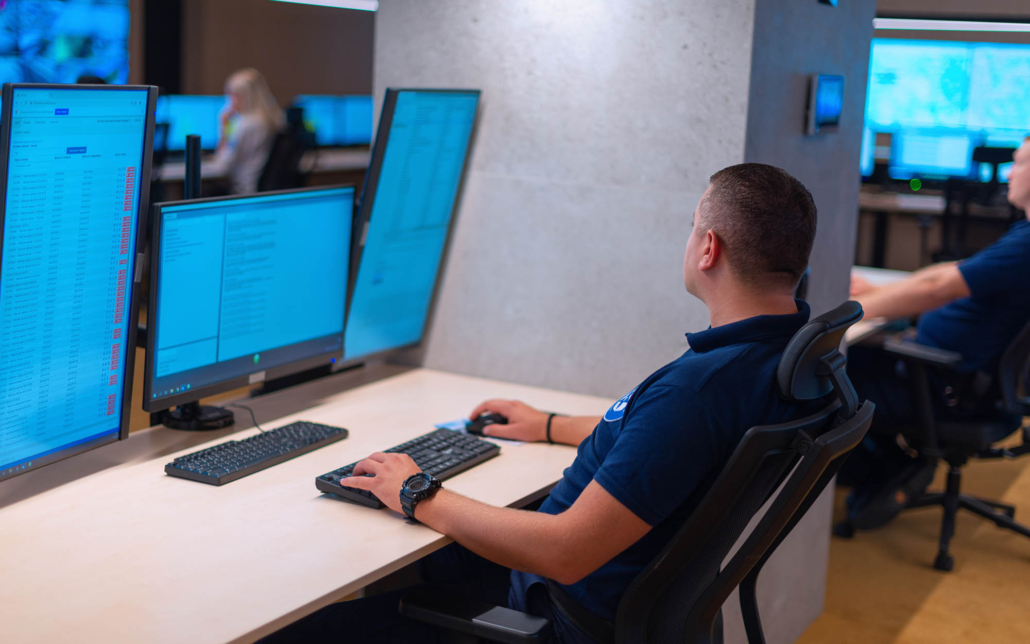 Person with large monitors looking over data