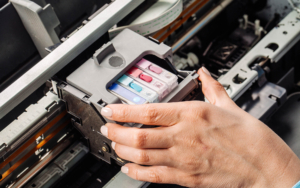 Printer Maintenance person swapping out printer ink