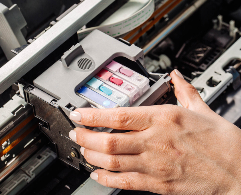 Printer Maintenance person swapping out printer ink