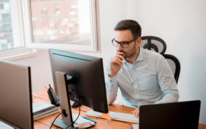 View of a person monitoring status on computer