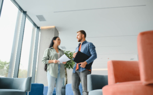 View of two people having a conversation in office