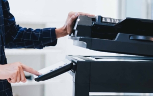 Copier printer, Close up hand office man press copy button on panel to using the copier or photocopier machine for scanning document printing a sheet paper