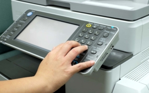 Hand pressing button on photocopy