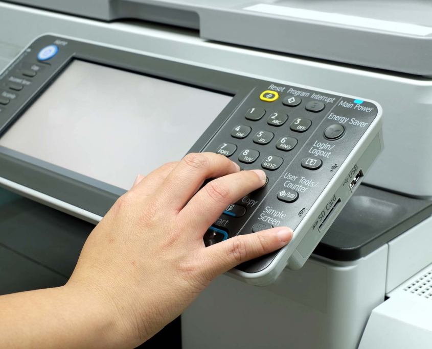 Hand pressing button on photocopy