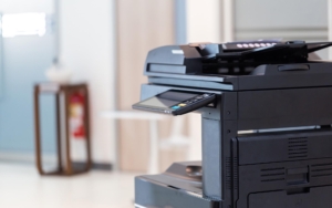 Side view of a large multi function printer and copier