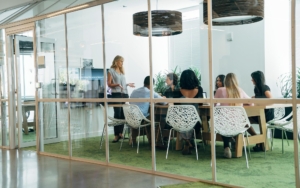 Side view of group of people having a meeting in room