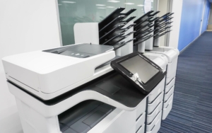 Side view of various multi function printers in office