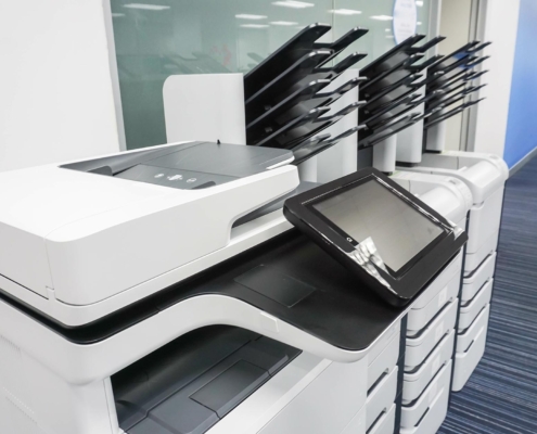 Side view of various multi function printers in office