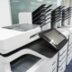 Side view of various multi function printers in office