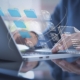 Image of a person using document management system on a laptop.