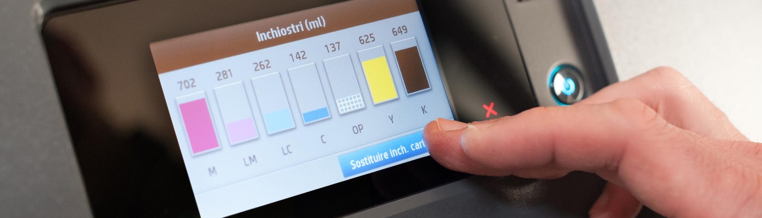 A person checking the ink levels on a printer.