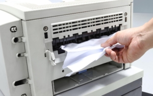 A printer with jammed paper.