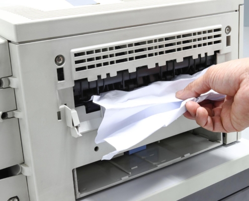 A printer with jammed paper.