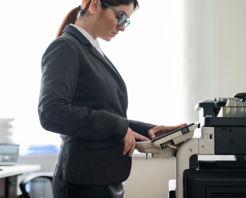 sideview of office woman printing