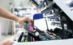 sideview of someone maintaining printer