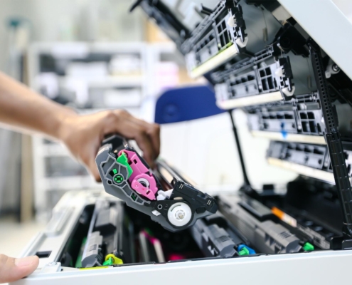 sideview of someone maintaining printer