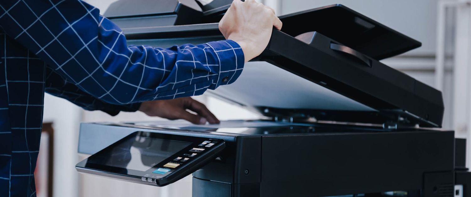 Side view of person using an office printer