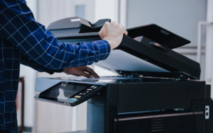 Side view of person using an office printer