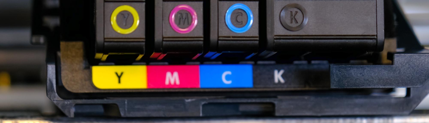 Close-up photo of yellow, magenta, cyan, and black ink cartridges