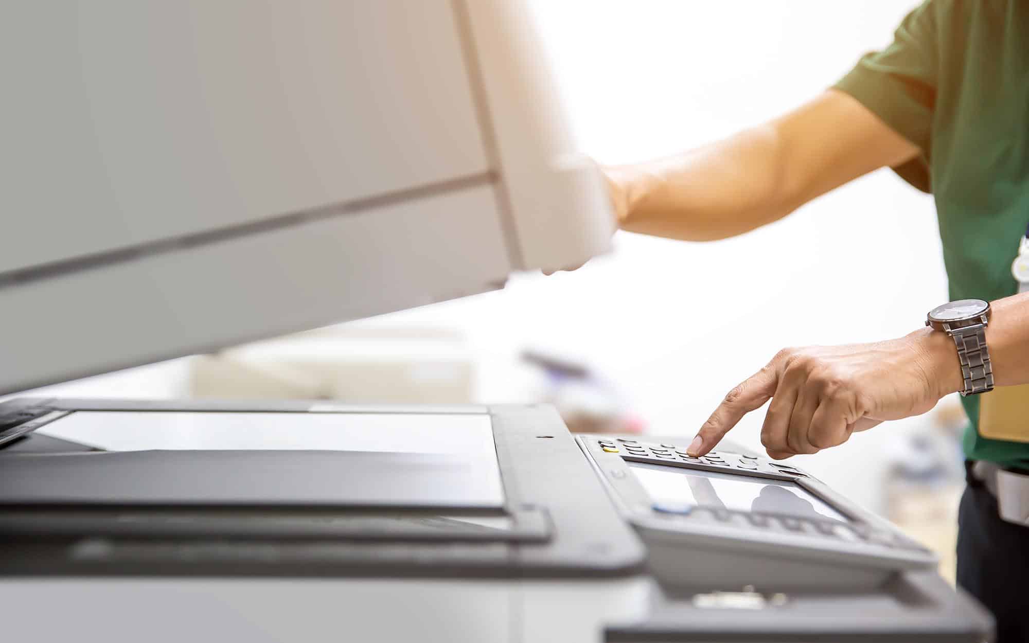 Side view of a person operating a printer