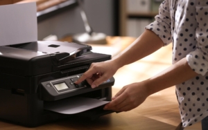 Side view of a woman operating a printer