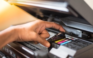 Side view of ink cartridges being replaced in a printer