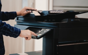 Side view of a person using a printer